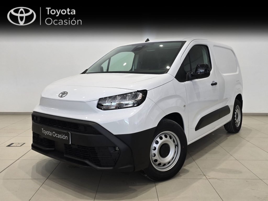 White Toyota van displayed in a showroom with Toyota Ocasión branding visible on the wall